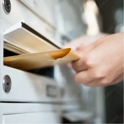 Man inserting envelope into the post box